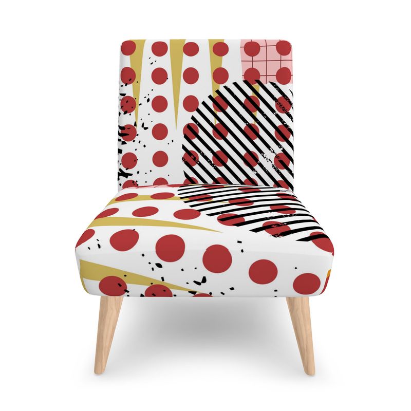 Front view Pop Art print which consists of large red circles, pink grid, long ochre spikes, black and white striped circle and golden yellow frame on armless accent chair with tapered beech wood legs.